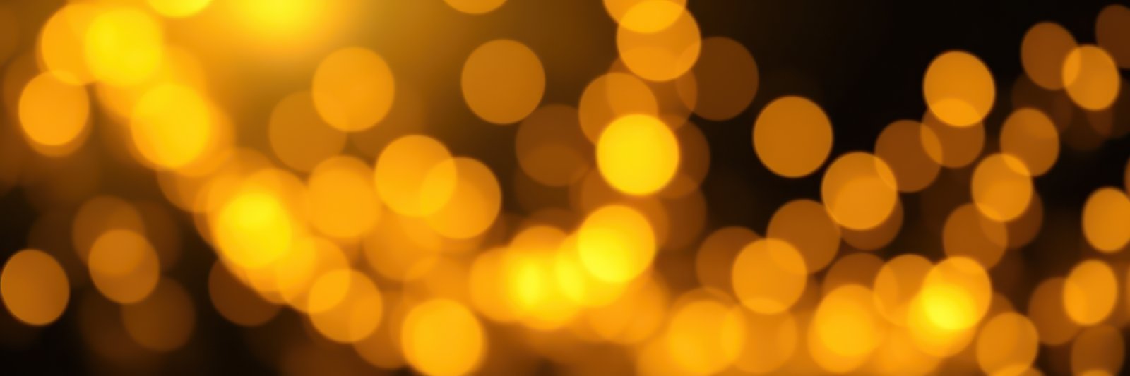 Bright golden bokeh lights shimmering in a festive atmosphere during the evening celebration